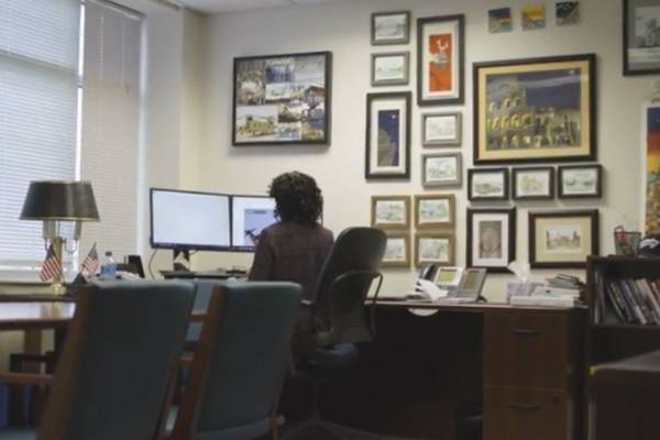Kristin Houston, graduate of Villanova's EMBA program, sits at a desk looking at her computer.