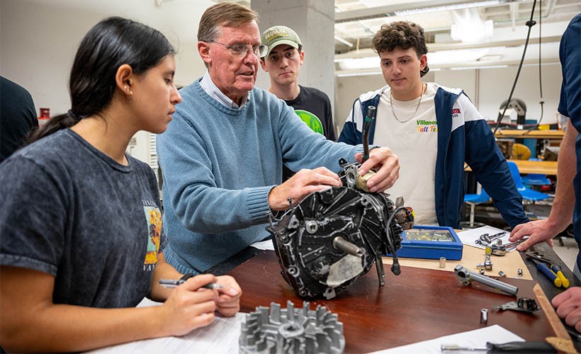 Students work on an engine with Professor Jim O'Brien.