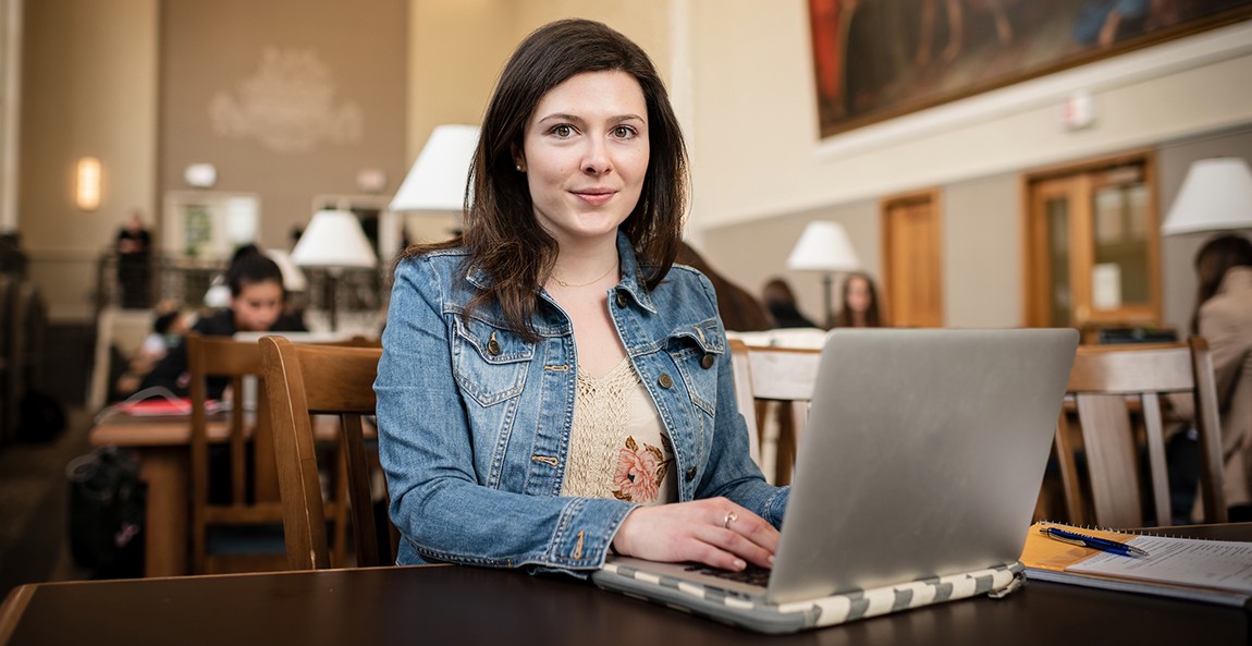 graduate student studying in the library
