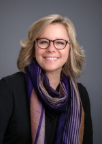 Female asstitant dean smiling with glasses