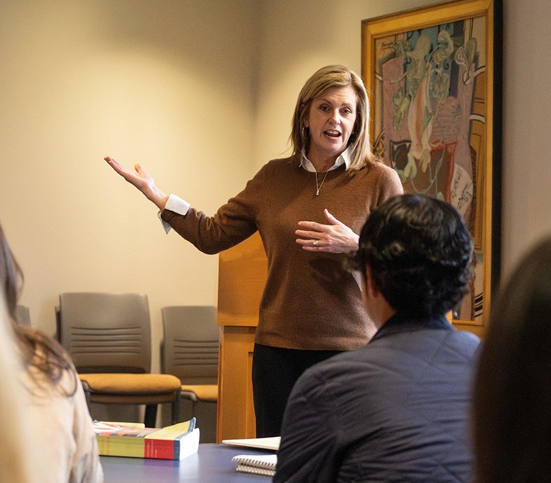 faculty member speaking in front of a classroom