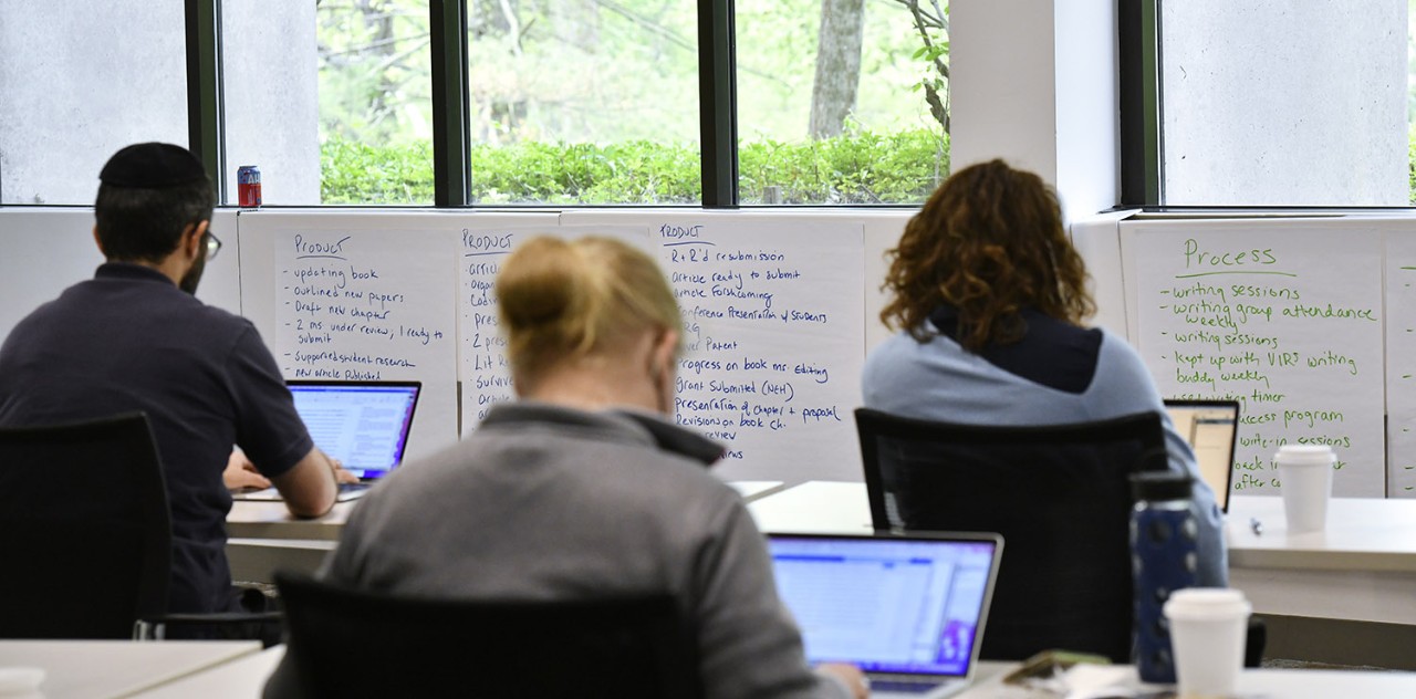 Faculty working on laptops in a writing workshop