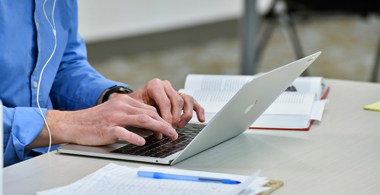 person typing on a laptop