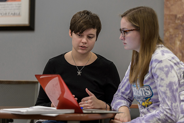 Students work together at a computer.