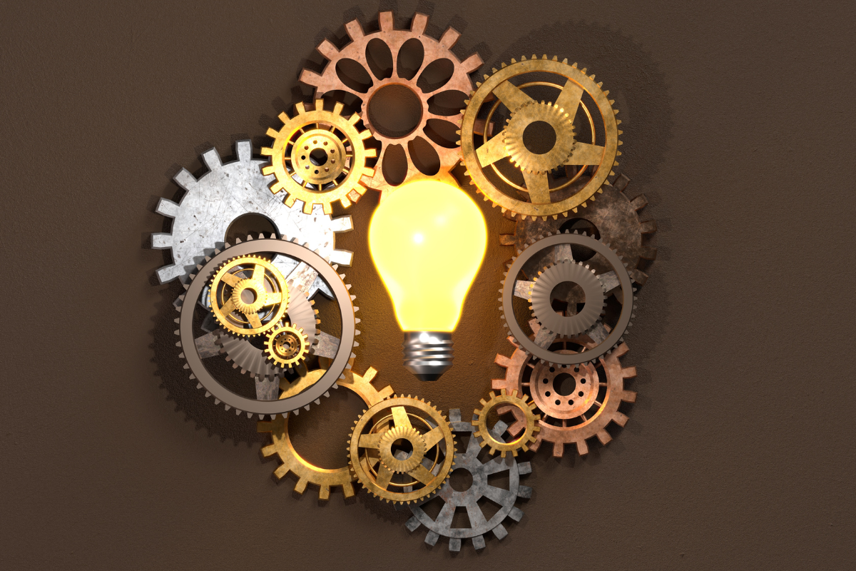 image of mechnical gears surrounding a lit lightbulb