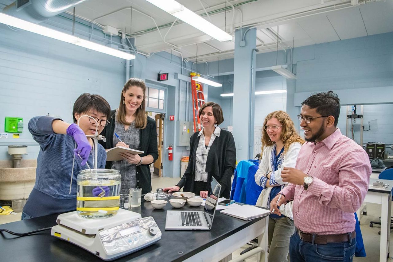 Professor Kristin Sample-Lord and other researchers observe a novel testing method in the lab